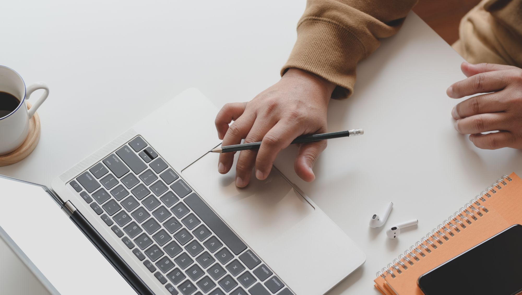 Mortgage Broker in Norfolk, VA, working at their computer, reviewing mortgage applications and assisting clients with home financing.